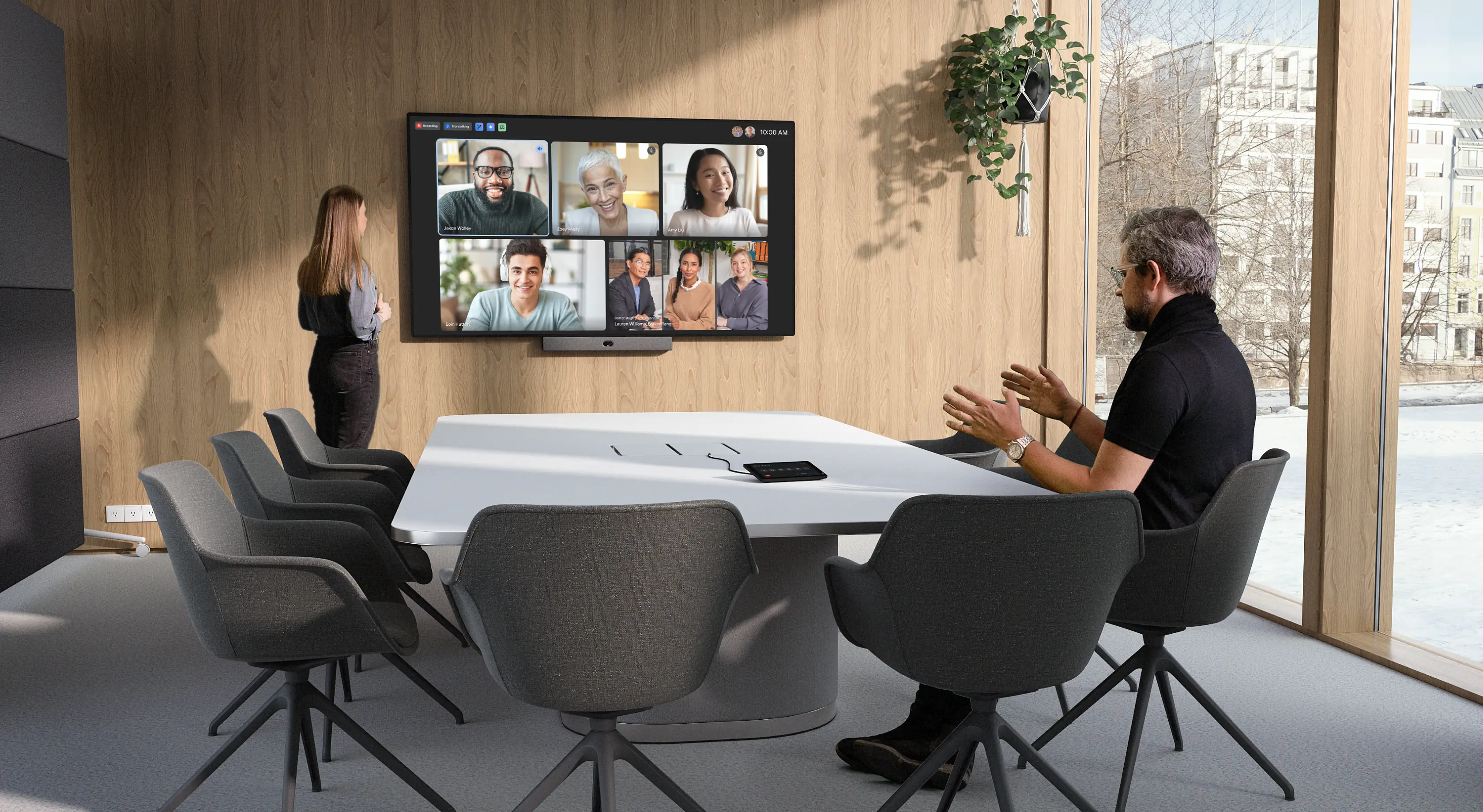 People in a meeting in a large meeting space equipped with Neat Bar Pro, Neat Center, and Neat Pad.